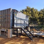 Modular containerised building with fabricated steel access stairs and handrails