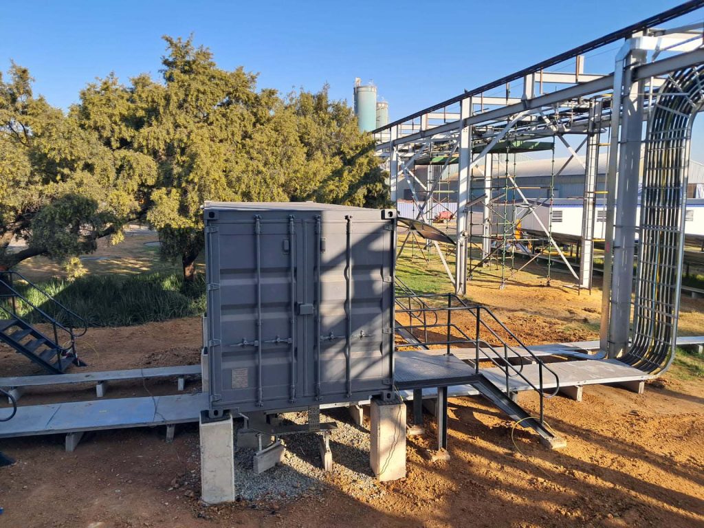 Containerised unit being positioned on a prepared steel base frame