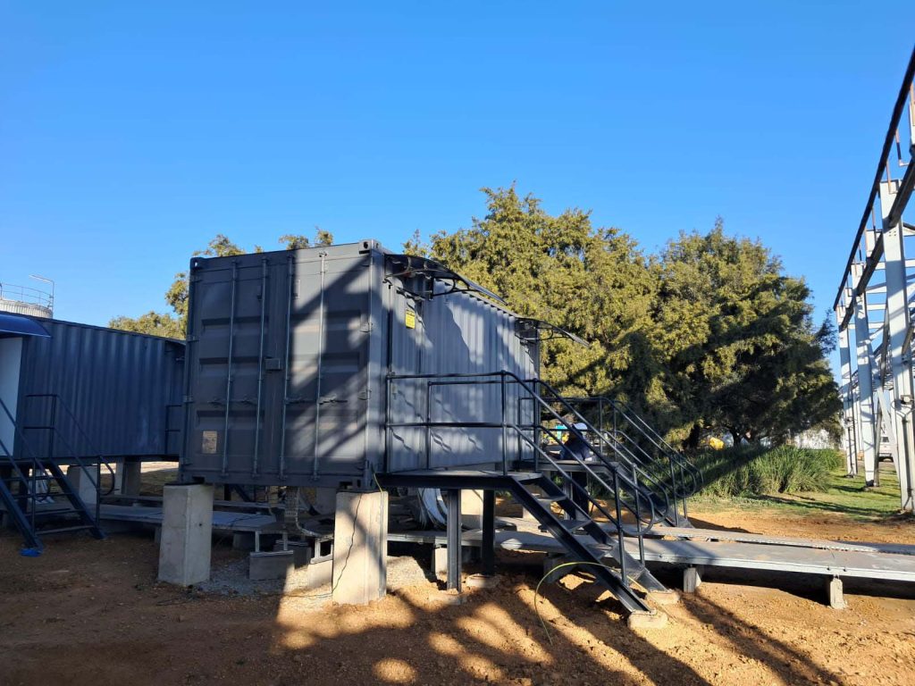 Row of containerised plant rooms installed at an industrial facility